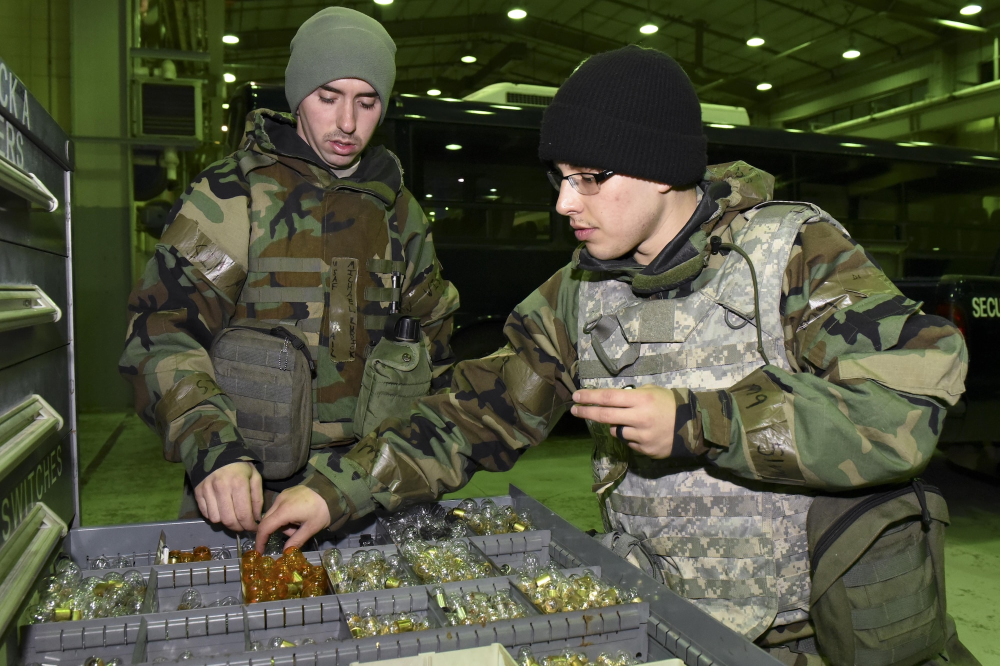 U.S. Air Force Airman 1st Class Seth Rojas and Airman 1st Class Michael Lubick, 8th Logistics Readiness Squadron fire truck and refueller mechanics, search for a replacement bulb in a bin during exercise Beverly Pack 17-2, a no-notice training exercise at Kunsan Air Base, Republic of Korea, March 7, 2017. An assortment of parts are needed to support the different types of vehicles airmen use in support of the 8th Fighter Wing mission. (U.S. Air Force photo by Senior Airman Michael Hunsaker/Released)