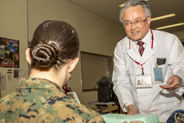 Dr. Terumasa Fujii, with the Japanese Red Cross Society, greets a U.S. Marine during the blood drive at Marine Corps Air Station Iwakuni, Japan, March 7, 2017. Dr. Fujii was responsible for checking the donor’s blood pressure before giving blood. The drive ended with a total of 59 donors, 15 of which were U.S. service members, and approximately 24,000 milliliters of blood.  (U.S. Marine Corps photo by Pfc. Stephen Campbell)
