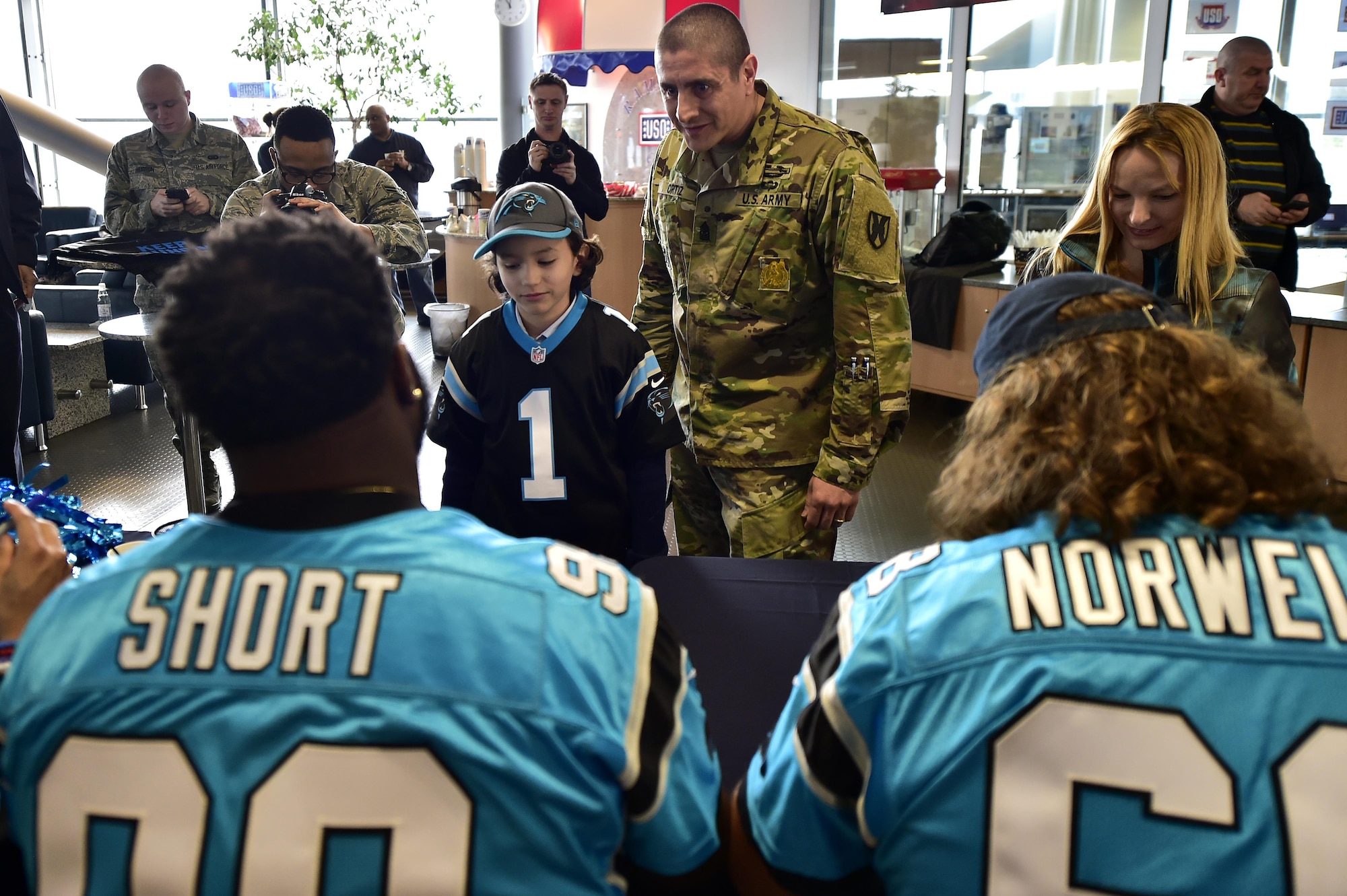 Carolina Panthers sign autographs for fans during a meet and greet at the 721st Aerial Port Squadron’s Passenger Terminal on Ramstein Air Base, Germany, March 6, 2017. Panther’s players flew to Germany as part of the United Service Organization’s efforts to improve the lives of service members across the world. (U.S. Air Force photo by Senior Airman Jonathan Bass)