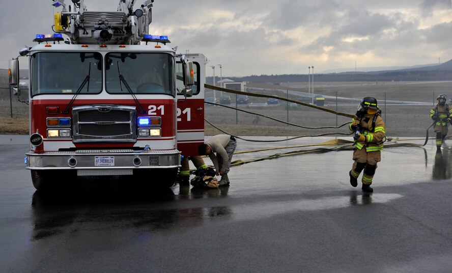 Airmen respond to simulated building fire outside Fire Station one on Ramstein Air Base, Germany, Mar. 7, 2017. The building fire simulator trains Airmen how to react in emergency situations. (U.S. Air Force photo by Airman 1st Class D. Blake Browning)
