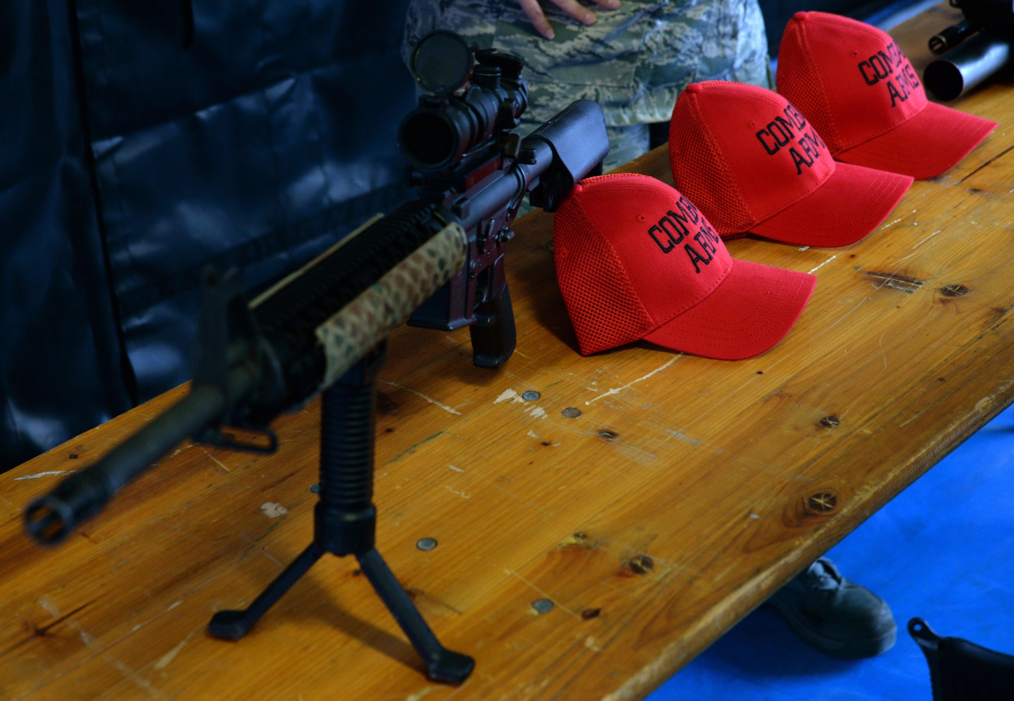 A firearm is displayed on a table at the 569th United States Forces Police Squadron training area on Kapaun Air Station, Germany, Mar. 7, 2017. Combat Arms Training and Maintenance Airmen showcase weaponry for several Carolina Panthers players and cheerleaders during a visit to the 569th USFPS training area. (U.S. Air Force photo by Airman 1st Class D. Blake Browning)