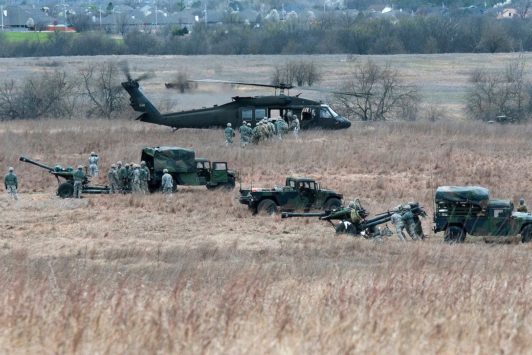 Oklahoma Army National Guardsmen prepare towed howitzers and UH-60 Black Hawk helicopters during slingload training and a live-fire range at Fort Sill, Okla., March 4, 2017. The guardsmen are assigned to the 1st Battalion, 160th Field Artillery Regiment, and the pilots and crew chiefs are assigned to Charlie Company, 1st Battalion, 244th Aviation Regiment. Oklahoma Army National Guard photo by Sgt. Bradley Cooney