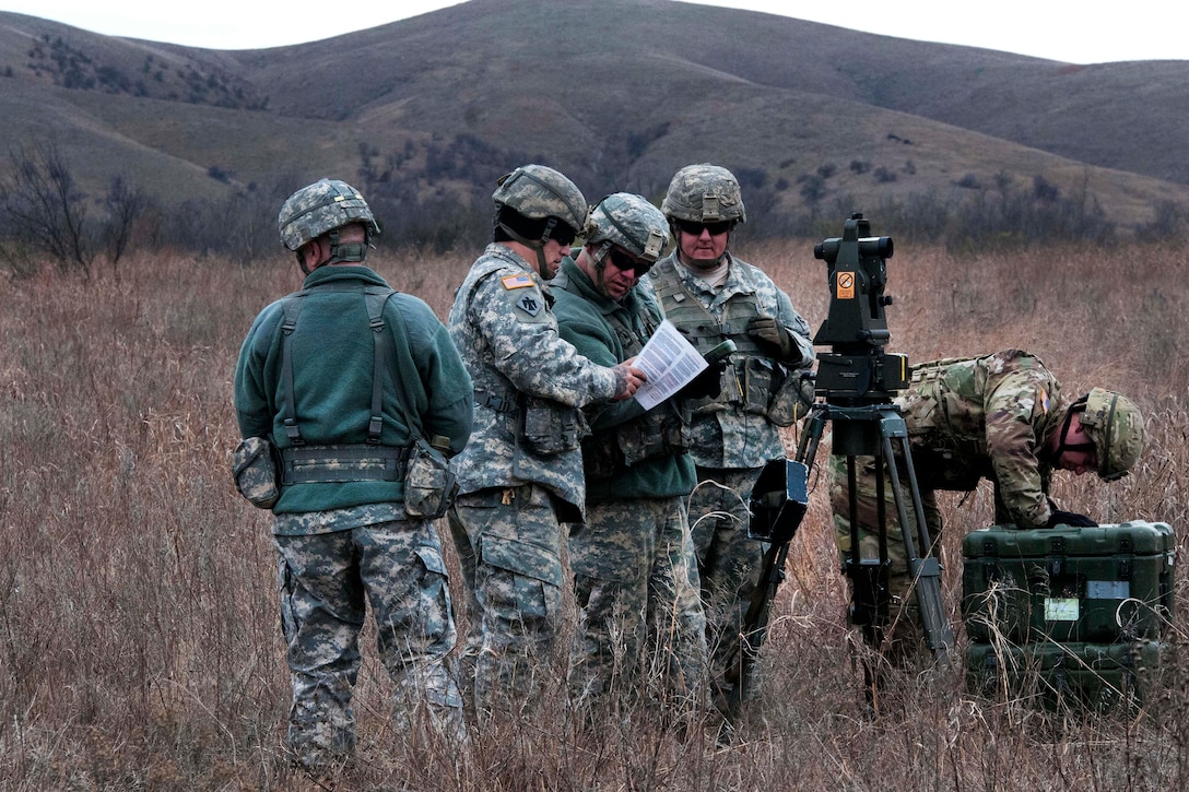 Oklahoma Army National Guardsmen review their mission instructions as they calculate and determine the range of targets during slingload and live-fire training at Fort Sill, Okla., March 4, 2017. Oklahoma Army National Guard photo by Sgt. Bradley Cooney