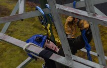 Senior Airman Jordan Watson, 1st Communications Maintenance Squadron cable and antenna theater maintenance technician, sets up a safety line during tower rescue and climbing training on Ramstein Air Base, Germany, March 9, 2017. A second cable was used for safety during the rescue training where a simulated victim was lowered to the ground. (U.S Air Force photo by Senior Airman Tryphena Mayhugh)