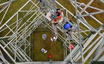 Tech. Sgt. Ryan Joslin, 1st Communications Maintenance Squadron NCO in charge of quality assurance assistance, lowers Staff Sgt. Tyler Crawford, 1 CMXS cable and antenna maintenance technician, to the ground during tower rescue and climbing training on Ramstein Air Base, Germany, March 9, 2017. Airmen were on the ground during the training to help soften the landing of the victim, but in a real-world situation they are not required. (U.S Air Force photo by Senior Airman Tryphena Mayhugh)