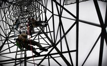 Staff Sgt. Ehren Brown, 1st Communications Maintenance Squadron unit deployment manager, hangs in the air as he is lowered to the ground during tower rescue and climbing training on Ramstein Air Base, Germany, March 9, 2017. The 1 CMXS Airmen were lowered approximately 50 feet during the rescue training. (U.S Air Force photo by Senior Airman Tryphena Mayhugh)
