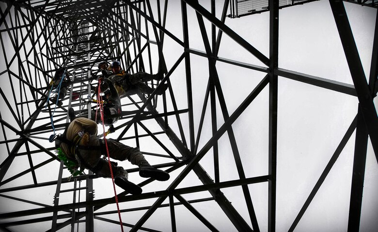 Staff Sgt. Ehren Brown, 1st Communications Maintenance Squadron unit deployment manager, hangs in the air as he is lowered to the ground during tower rescue and climbing training on Ramstein Air Base, Germany, March 9, 2017. The 1 CMXS Airmen were lowered approximately 50 feet during the rescue training. (U.S Air Force photo by Senior Airman Tryphena Mayhugh)