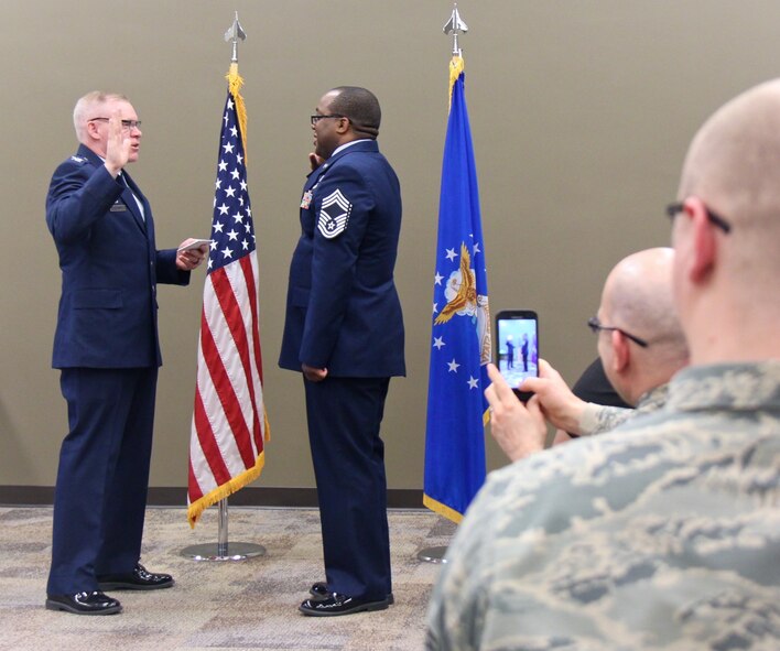 At left, the commander of the 932nd Medical Group, Col. Leon Barringer, performs the oath of enlistment to Chief Master Sgt. Robert Cutchins after his new chief's stripe was put on. The colonel recognized the dedication and contributions of both the chief and his family in a special promotion ceremony held March 5, 2017. A packed room of fellow Airmen came out to witness the event on Scott Air Force Base, near Belleville, Illinois. Chief Cutchins is the Superintendent of Health Services Management at the 932nd Medical Squadron, 932nd Medical Group. The 932nd MDS trains and equips 188 medical personnel on the performance of duties associated with the Expeditionary Medical Support (EMEDS) mission. (U.S. Air Force photo by Lt. Col. Stan Paregien)