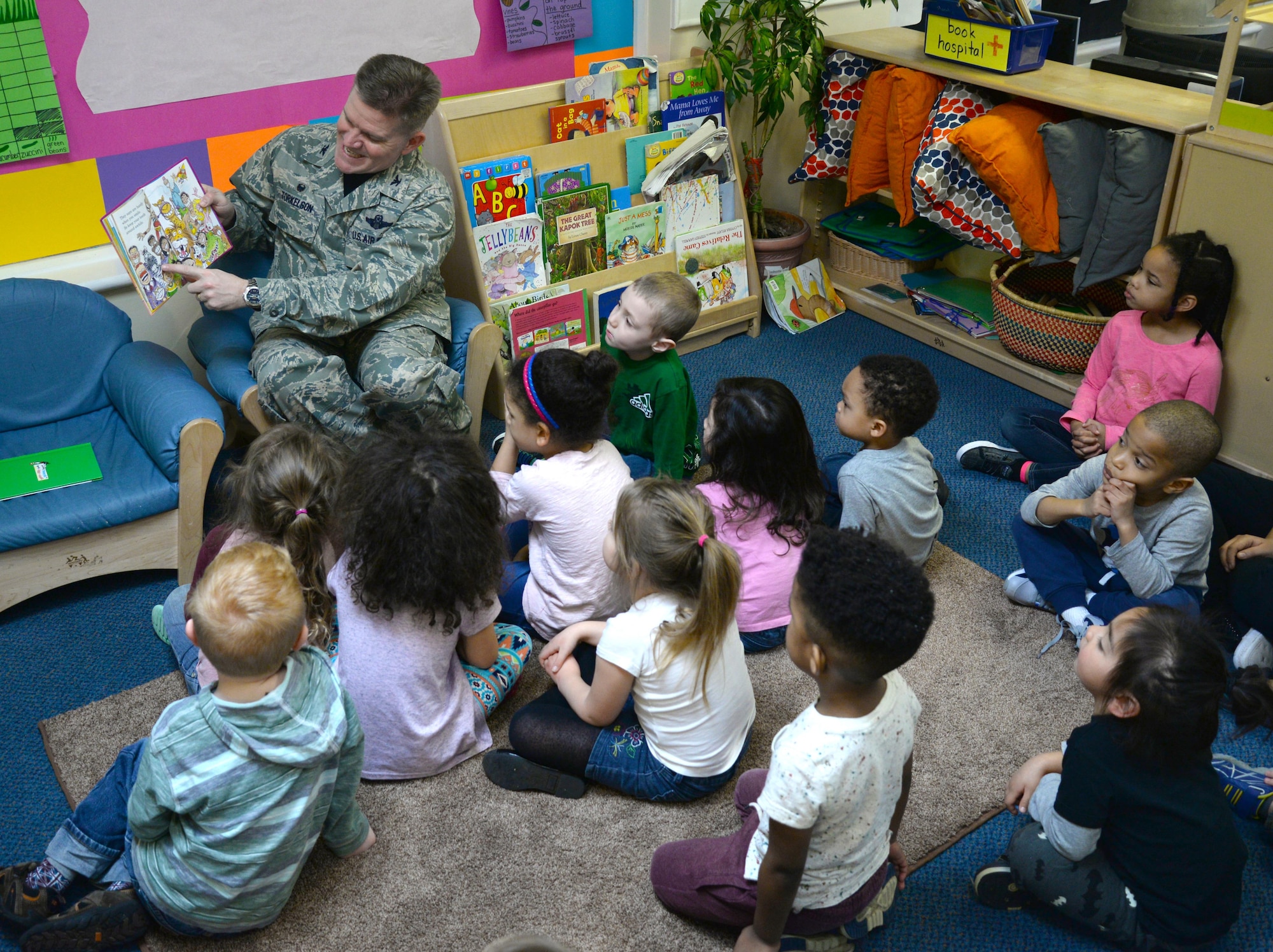 U.S. Air Force Col. Thomas Torkelson, 100th Air Refueling Wing commander, top left, reads a Dr. Seuss book to a class of children, March 3, 2017, at the Child Development Center on RAF Mildenhall, England. The CDC celebrated the author’s birthday by hosting Team Mildenhall commanders and promoting reading to their students. Prior to the reading, Torkelson announced the winner of the door decoration competition. (U.S. Air Force photo by Senior Airman Justine Rho)
