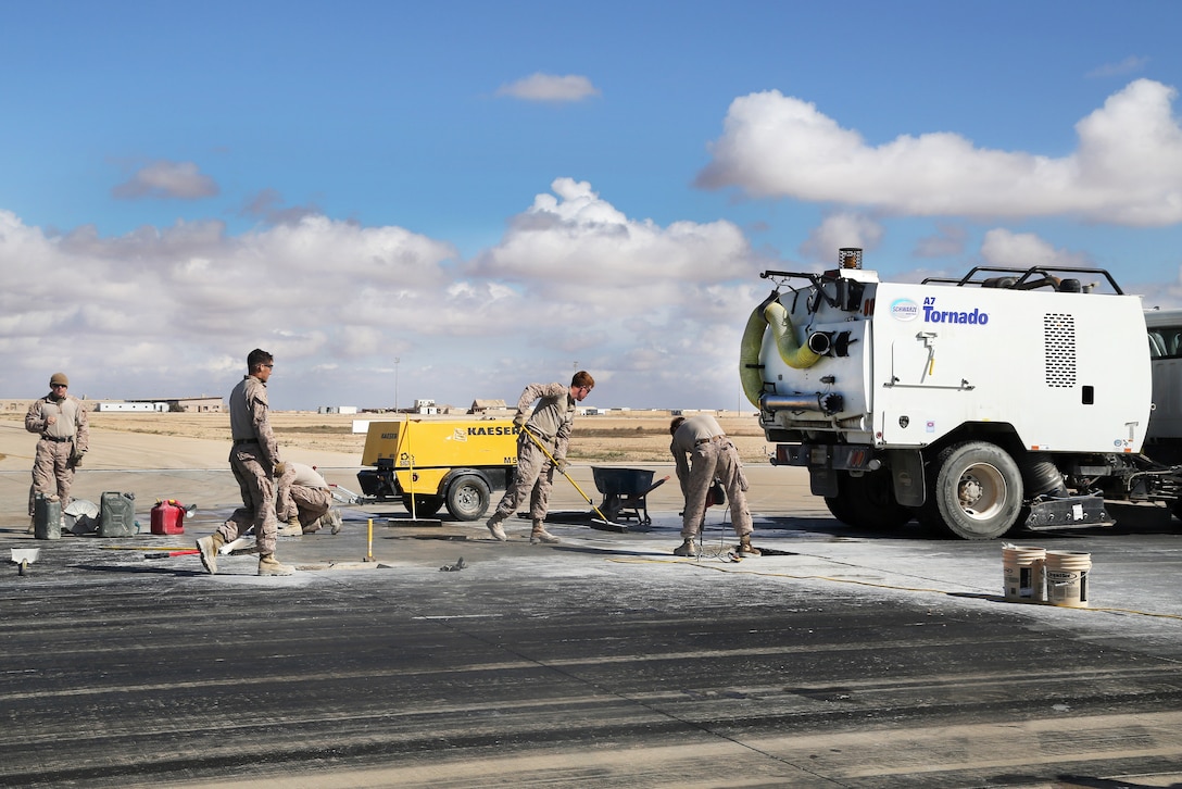 Marines maintain a runway at Al Asad Air Base, Iraq, March 4, 2017. The Marines are assigned to Task Force Al Asad. Airfield maintenance is conducted to keep the airfield safe for aircraft use and to maintain daily operations in support of Combined Joint Task Force Operation Inherent Resolve. Army photo by Sgt. Lisa Soy
