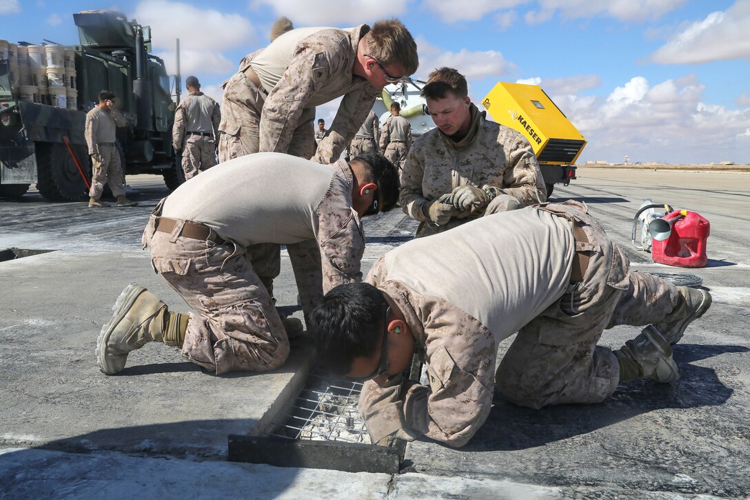 Marines prep a pothole for to be filled with concrete during maintenance on a runway at Al Asad Air Base, Iraq, March 4, 2017. Army photo by Sgt. Lisa Soy