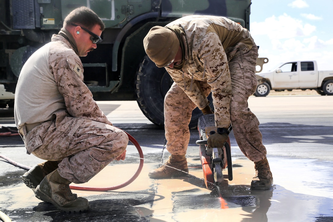 Marines cut through the tarmac on a runway during maintenance at Al Asad Air Base, Iraq, March 4, 2017. Army photo by Sgt. Lisa Soy