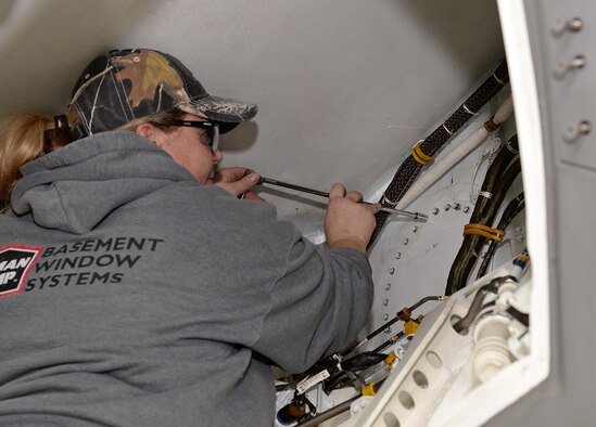 Kari Izatt, F-35 Lightning II maintainer, tightens bolts on the Lower Fuel Panel prior to the last Structural Life Limiting Parts (SLLP) program F-35 aircraft being rolled out of the depot maintenance hangar. (U.S. Air Force photo by Alex R. Lloyd)