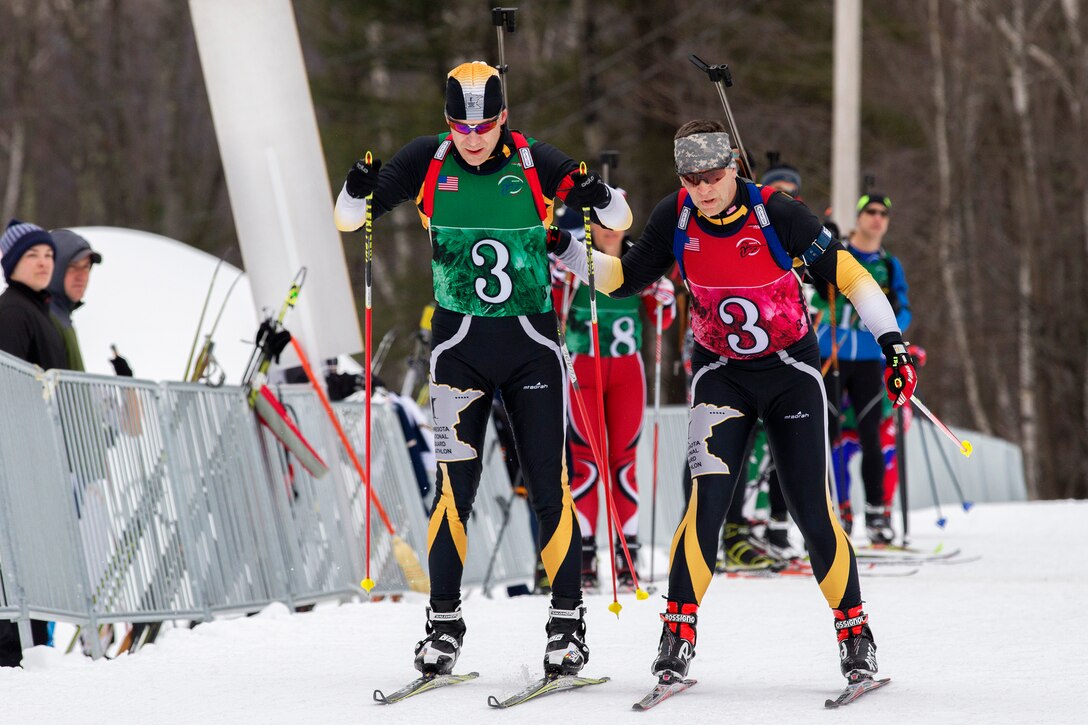 Minnesota Army National Guard Lt. Col. Paul Peterson, right, tags in  his teammate, Sgt. 1st Class Frank Gangi, during a biathlon at Camp Ethan Allen Training Site in Jericho, Vt., March 7, 2017. Vermont Army National Guard photo by Spc. Avery Cunningham