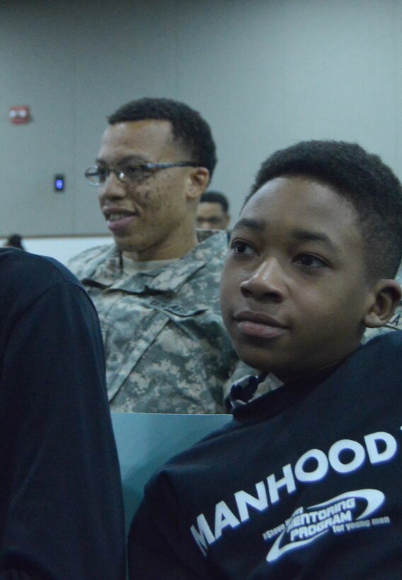 U.S. Army Reserve Staff Sgt. Paul Word, 300th Sustainment Brigade, sits with young men participating in a Steve and Marjorie Harvey Foundation Mentoring Camp in Dallas, TX, on Feb. 4, 2017.  Staff Sgt. Word was selected to mentor a group of young men throughout the event. For the past six years the U.S. Army Reserve has partnered with the Steve and Marjorie Harvey Foundation to provide Soldier-mentors for camps around the country. (U.S. Army Reserve Photo by Maj. Brandon R. Mace)