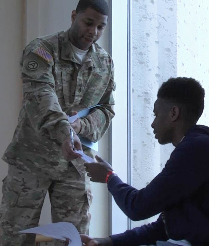 U.S. Army Reserve Staff Sgt. Anthony Corbin helps a young man with a scavenger hunt at the African American History Museum in Dallas, TX, on Feb. 4, 2017.  The scavenger hunt was part of a Steve and Marjorie Harvey Foundation Mentoring Camp.  For the past six years the U.S. Army Reserve has partnered with the Steve and Marjorie Harvey Foundation to provide Soldier-mentors for camps around the country. (U.S. Army Reserve Photo by Maj. Brandon R. Mace)