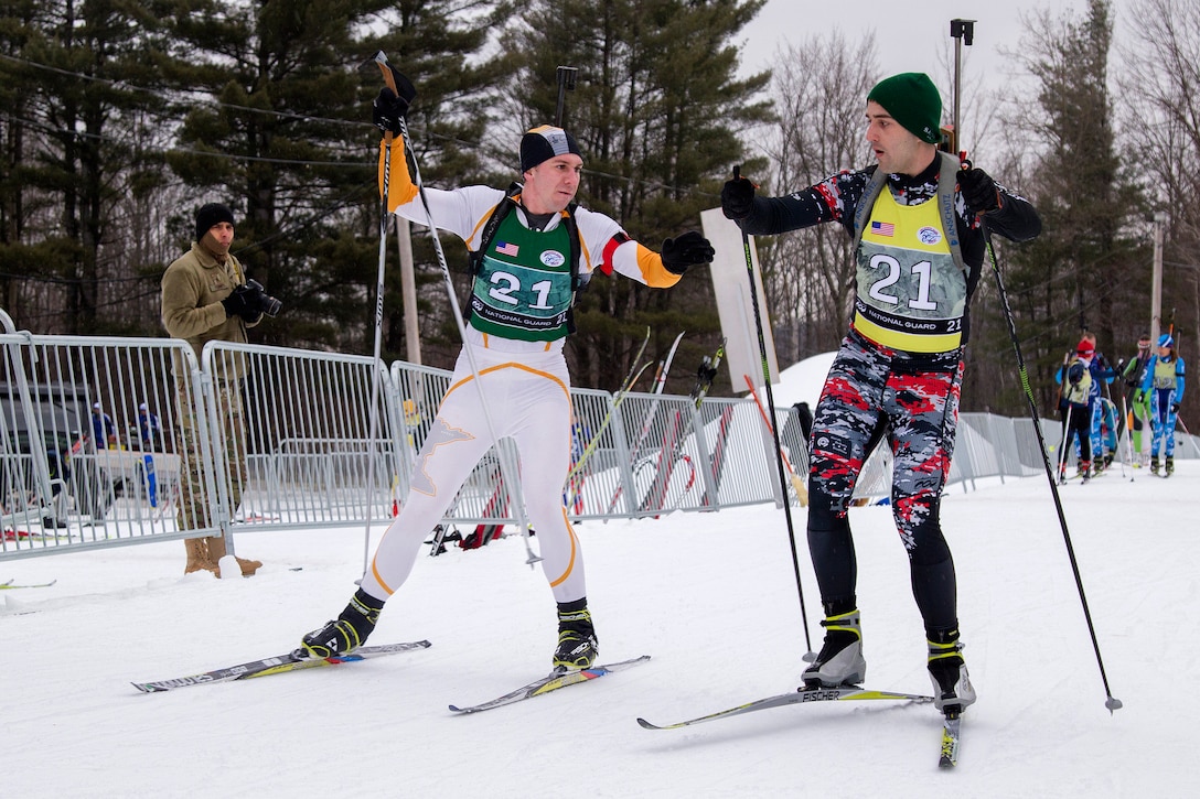 Minnesota Army National Guard Sgt. Jared Becker, left, tags in his teammate, North Dakota Army National Guard Spc. Brett Butler, during a biathlon at Camp Ethan Allen Training Site in Jericho, Vt., March 7, 2017. Vermont Army National Guard photo by Spc. Avery Cunningham