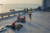 Kuwait- Soldiers drift in a raft, no land in sight, awaiting rescue from the USAV Churubusco- a Landing Craft Utility vessel-  the crew, 481 det. 1, transportation company, California, during a personnel recovery training mission using  Bravo Company, 1-111th, Florida, Soldiers for the personnel lost at sea; the crew perform a grid pattern and use lookouts once located there is mock medical aid, Feb. 13. 
(Photo by Army Sgt. 1st Class Suzanne Ringle/Released)