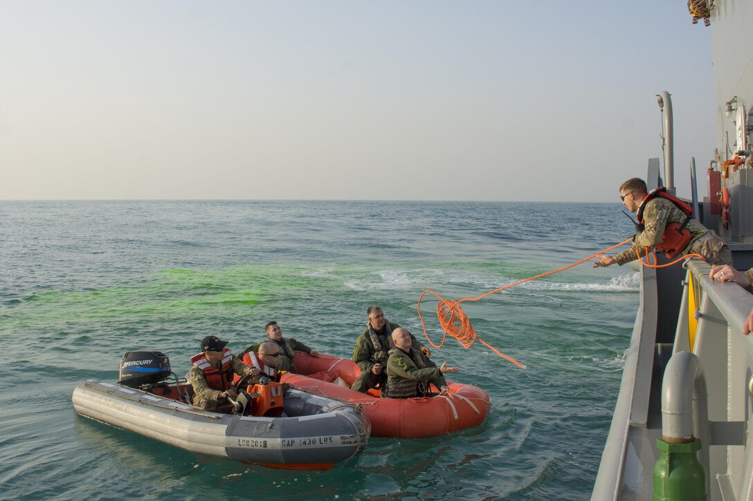 Kuwait- Soldiers with Bravo Company, 1-111th Aviation Regiment, Florida, and 77th Combat Aviation Brigade, Arkansas, grab a rescue rope while participating in a personnel recovery mission with the crew of LCU2013 Churubusco- a Landing Craft Utility vessel from Detachment 1, 481st Transportation Company, California, in an exercise replicating a downed aircraft scenario, Feb. 13. 
(Photo by Army Sgt. 1st Class Suzanne Ringle/Released)