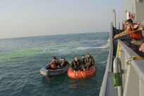 Kuwait- Soldiers with Bravo Company, 1-111th Aviation Regiment, Florida, and 77th Combat Aviation Brigade, Arkansas, grab a rescue rope while participating in a personnel recovery mission with the crew of LCU2013 Churubusco- a Landing Craft Utility vessel from Detachment 1, 481st Transportation Company, California, in an exercise replicating a downed aircraft scenario, Feb. 13. 
(Photo by Army Sgt. 1st Class Suzanne Ringle/Released)