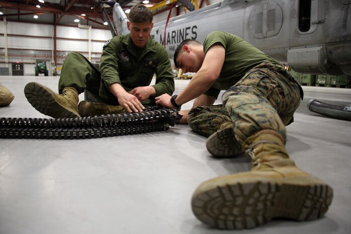 Lance Cpl. Collin Stewart (left) and Pfc. Stetson Kirkpatrick (right) repair a piece of ordnance equipment from a UH-1Y Venom aboard Ft. Drum, N.Y., Mar. 9, 2017. Marines with Marine Light Attack Helicopter Squadron 269, Marine Aircraft Group 29, 2nd Marine Aircraft Wing arrived at Ft. Drum Mar. 8, and will spend more than a week conducting aerial operations in the cold environment. The training will also offer the Marines a unique opportunity to come out of their comfort zone and build unit cohesion. Stewart and Kirkpatrick are aviation ordnance technicians assigned to HMLA-269. (U.S. Marine Corps photo by Cpl. Mackenzie Gibson/Released)