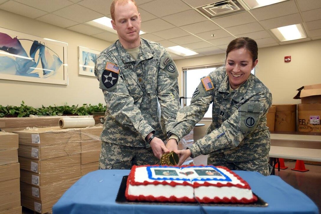 Maj. Russell Litko, left, and Capt. Rebecca Spohr, cut a command cake following a headquarters and headquarters company change of command ceremony during the battle assembly weekend. Spohr assumed command of the 85th Support Command's HHC on February 12, 2017.
(Photo by Sgt. Aaron Berogan)