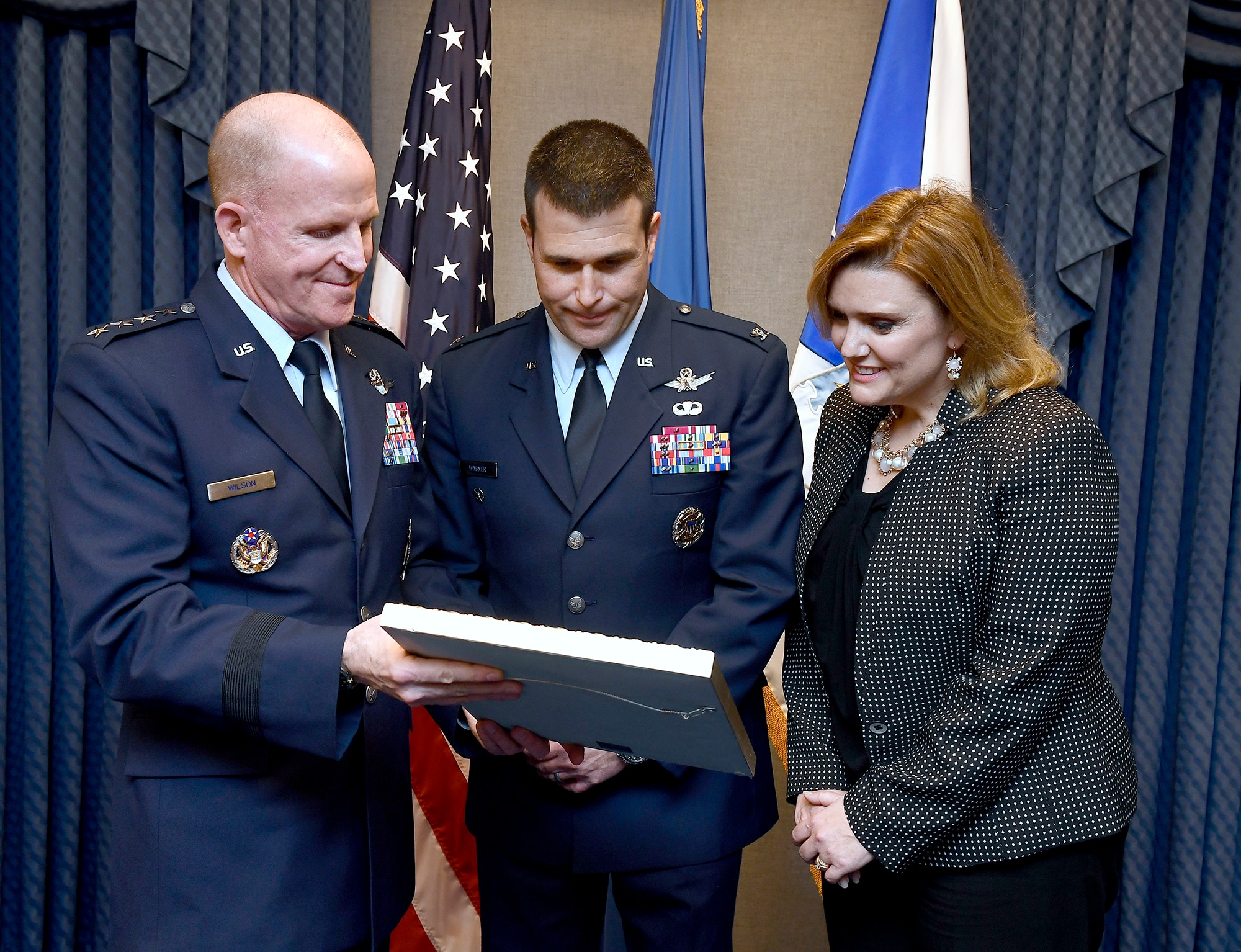 Gen. Stephen Wilson, the Air Force Vice Chief of Staff, presents the 2016 O'Malley Award to Col. John Wagner and his wife, Jennifer, during a Pentagon ceremony, March 7, 2017. The Wagners earned the award for their work at Buckley Air Force Base. Colo. (U.S. Air Force photo/Scott M. Ash)