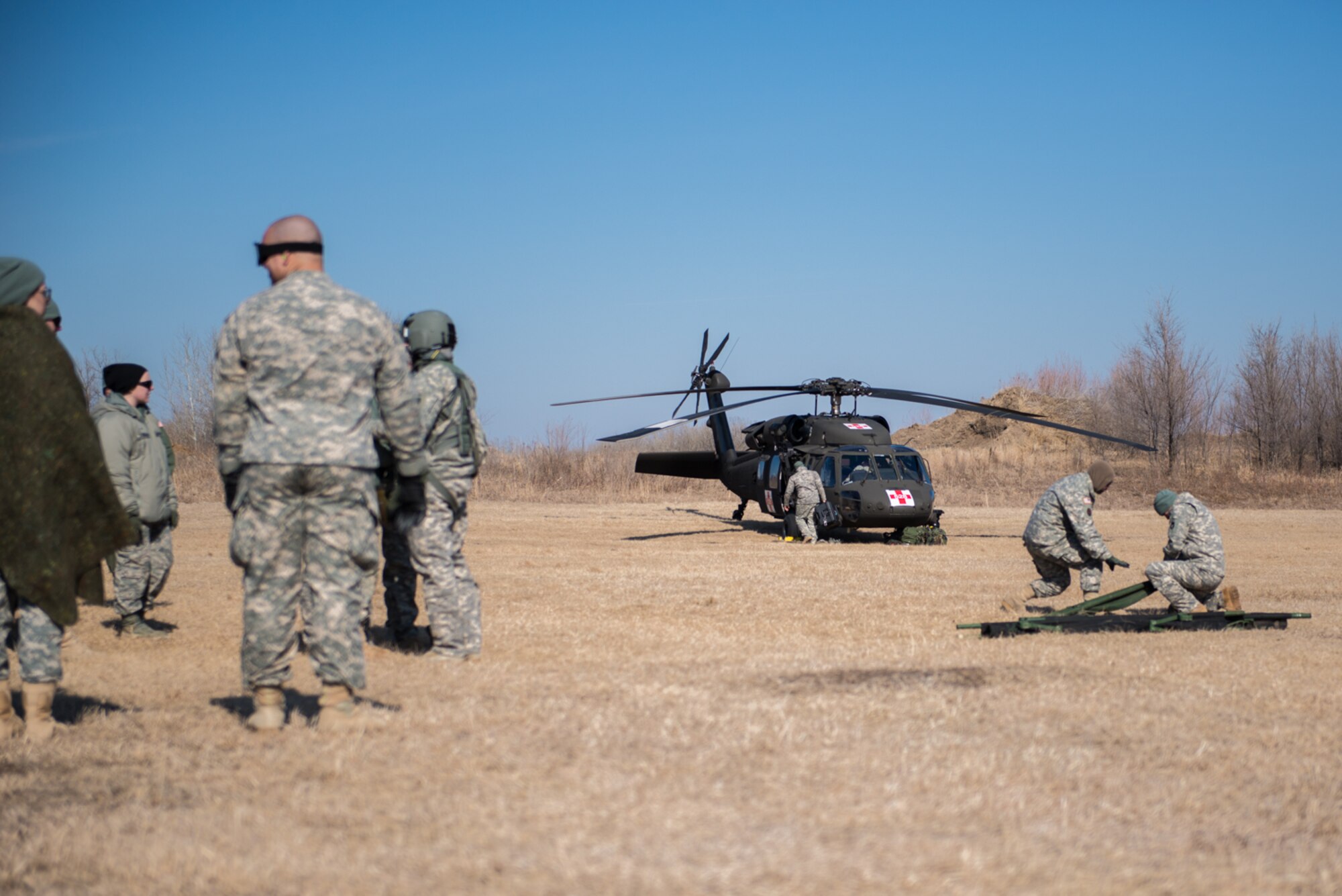 Members of the 934th Aeromedical Evacuation Squadron, 7405th Troop Medical Clinic, and 7212th Medical Support Unit prepare litters for transporting injured service members during a joint service medical evacuation training on March 4th, 2017 at Arden Hills Army Training Site. (U.S. Air Force photo by Senior Airman Samuel Wacha)