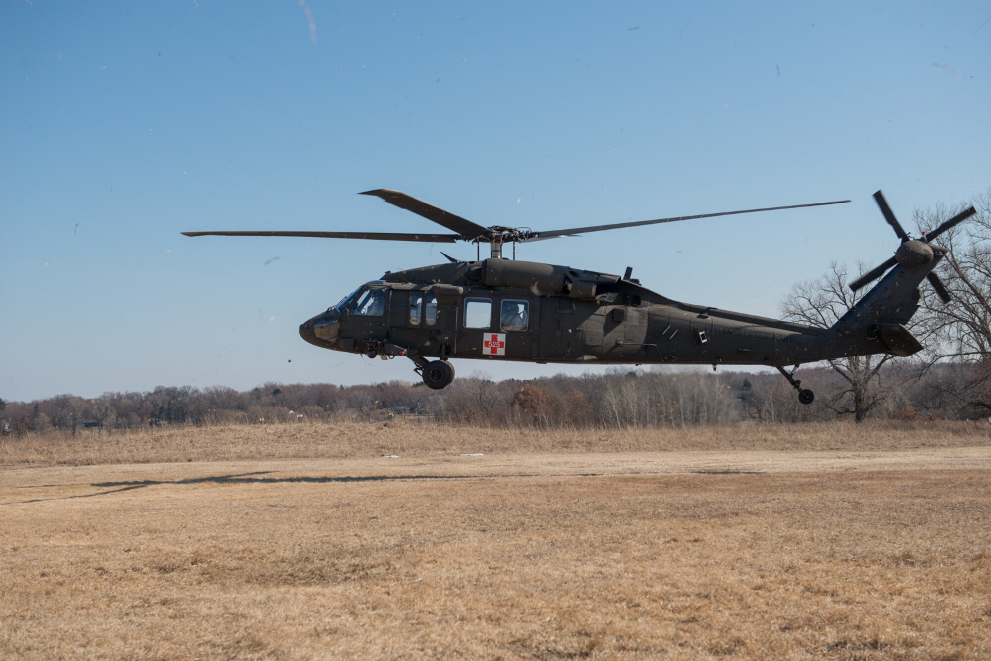 A UH-60 Blackhawk helicopter takes off after being loaded with a simulated injured service member during a joint service medical evacuation training on March 4th, 2017 at Arden Hills Army Training Site. (U.S. Air Force photo by Senior Airman Samuel Wacha)