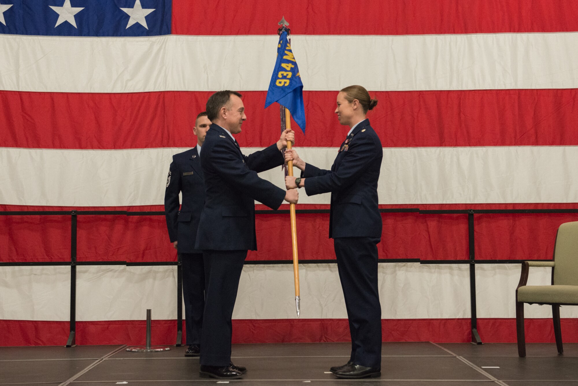 Col. Erik Sutcliffe, 934th Maintenance Group commander, presents Maj. Grace Miller, incoming commander of the 934th Aircraft Maintenance Squadron, with the squadron guidon March 4 at Minneapolis-St. Paul Air Reserve Station, Minn. (U.S. Air Force photo by Senior Airman Samuel Wacha)