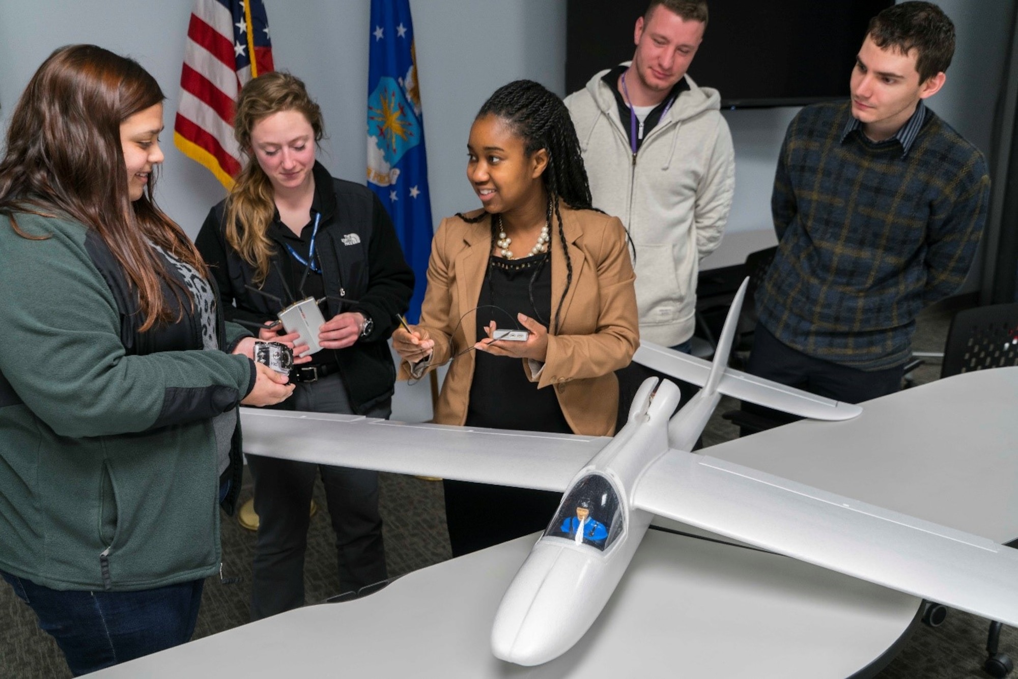 Adrienne Ephrem talks with students Morgan Oldham, Wright State University; Caitlyn Jenner, University of Dayton; Jamie Workman, Wright State University; and John Wintersohle, Wright State University about their AFRL joint unmanned aerial system project. They will use the Super Sky Surfer with a 94-inch wing span. (U.S. Air Force photo/Kwame Acheampong)