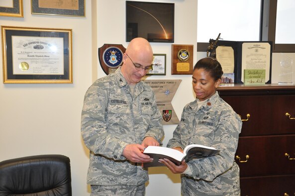 Col. Paul Cotellesso, Air University Detachment 1 Commander/
Director of Staff at the Air Force Institute of Technology, reviews a section of the Uniform Code of Military Justice with Maj. Jeanette Skow, AFIT Staff Judge Advocate. (U.S. Air Force photo/Bryan Ripple)