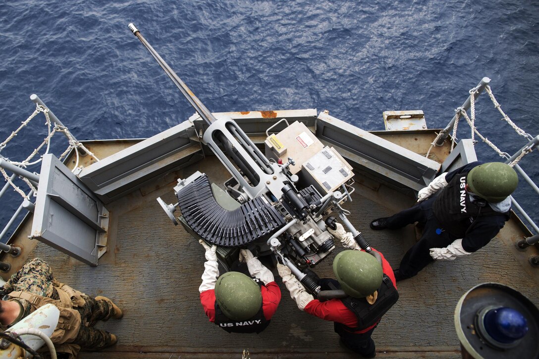 Navy Petty Officer 3rd Class Jonathan Fleet fires 25mm rounds from a MK 38 Mod 1 machine gun system aboard the amphibious assault ship USS Bonhomme Richard during a live-fire gun exercise in the Philippine Sea, March 10, 2017. The MK 38 Mod 1 was designed to counter high speed maneuvering surface targets. Navy photo by Seaman Jesse Marquez Magallanes