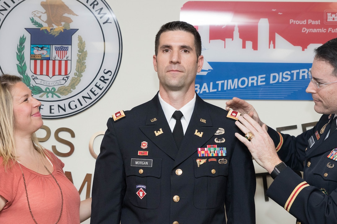Col. Ed Chamberlayne, Baltimore District commander, places shoulder boards with the rank of lieutenant colonel on Lt. Col. Brad Morgan, Baltimore District deputy commander, during a promotion ceremony from major to lieutenant colonel at the District Headquarters in Baltimore, March 1, 2017. Morgan's wife Rebecca is also pictured. (U.S. Army photo by Alfredo Barraza)  