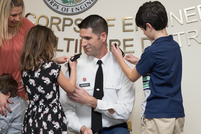 Lt. Col. Brad Morgan's son Aiden and daugther Ali place shoulder boards with the rank of lieutenant colonel on their father, during a promotion ceremony for the Baltimore District deputy commander from major to lieutenant colonel at the District Headquarters in Baltimore, March 1, 2017. Morgan's wife Rebecca and son knox are also pictured. (U.S. Army photo by Alfredo Barraza)  