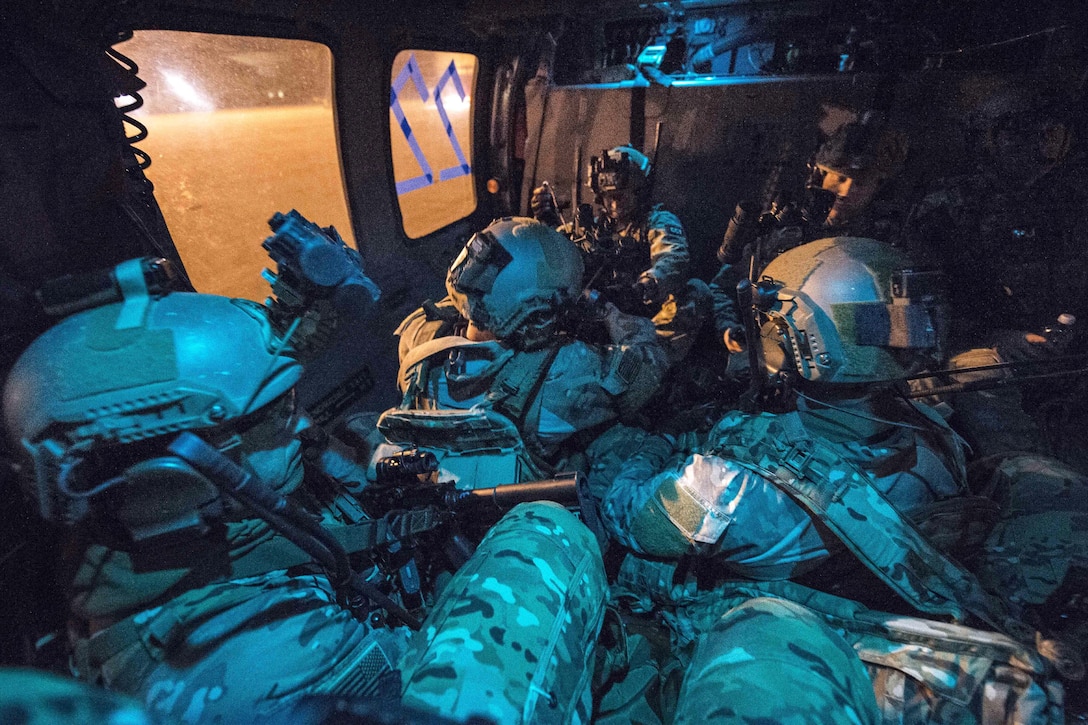 Airmen wait inside a Navy MH-60S Seahawk helicopter before takeoff during Emerald Warrior 17 at Hurlburt Field, Fla., March 2, 2017. Air Force photo by Staff Sgt. Corey Hook