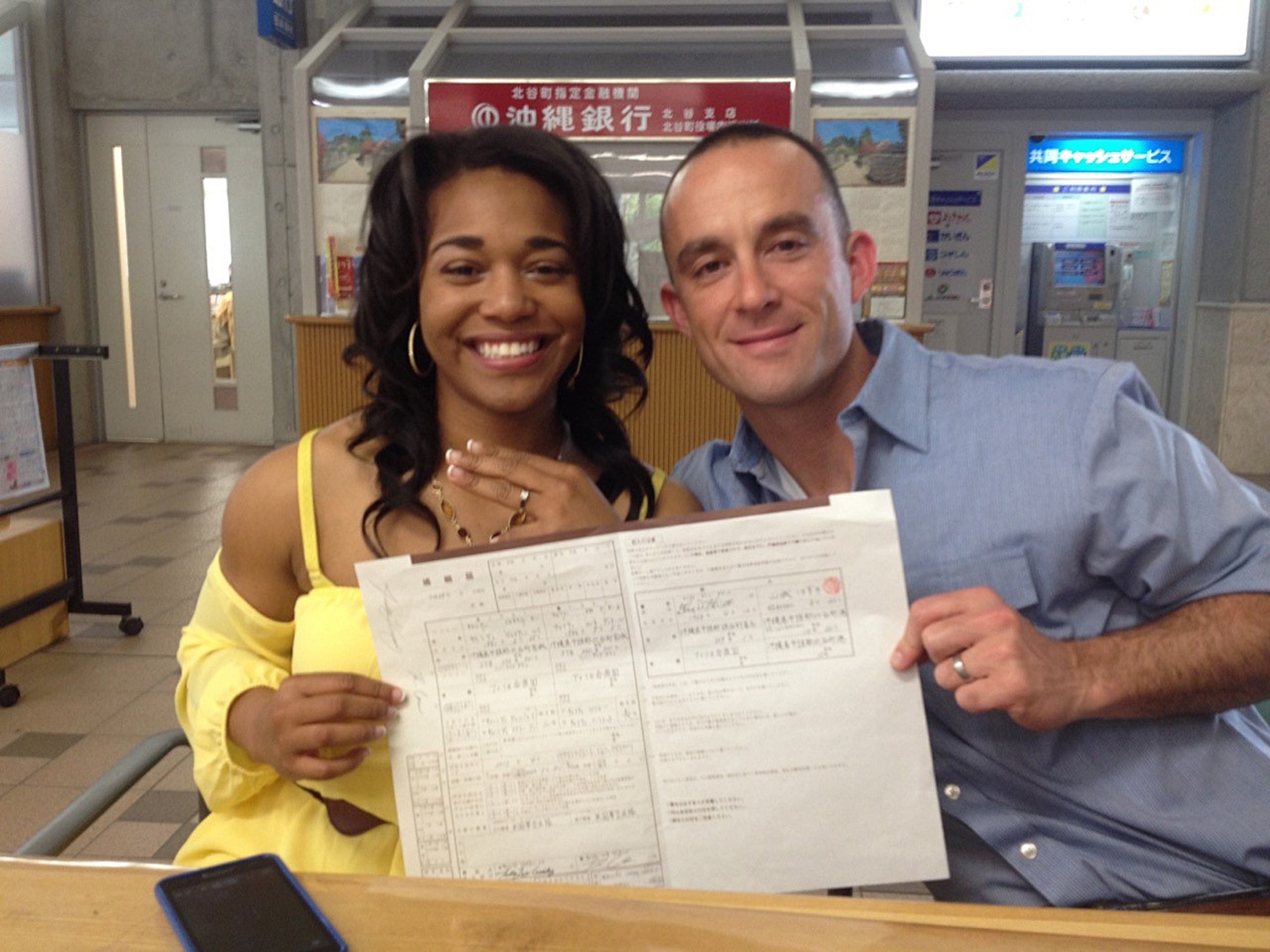 U.S. Air Force Capt. Renee Cassidy, the 509th Maintenance Operations officer in charge, and Capt. Justin Cassidy, the 13th Aircraft Maintenance Unit officer in charge, display their wedding certificate, written in Kanji, after getting married in Okinawa, Japan, May 2013. The Cassidys began long-distance dating in 2012 and were officially married in May 2013. Joint-spouse orders reunited the couple at Whiteman Air Force Base, Mo., in 2014. (Courtesy photo)