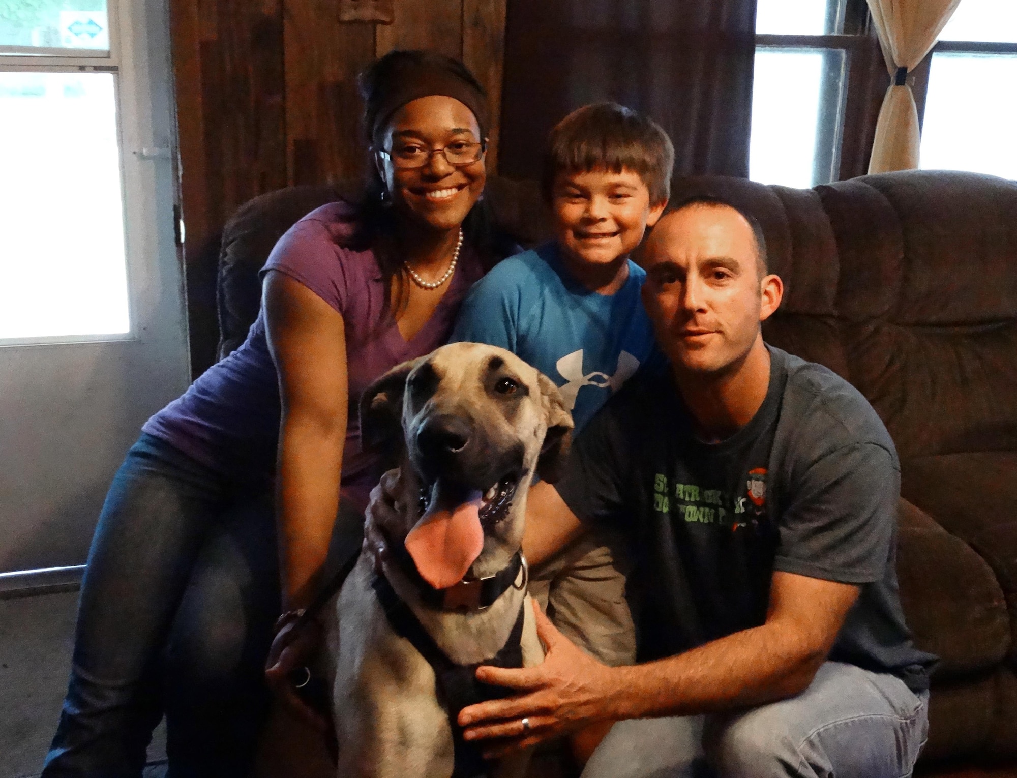 U.S. Air Force Capt. Justin Cassidy, the 13th Aircraft Maintenance Unit officer in charge, and Capt. Renee Cassidy, the 509th Maintenance Operations officer in charge, gather for a family photo with their son, Carson, and their Great Dane. (Courtesy photo)