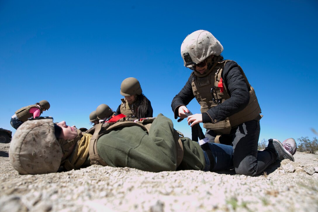 Melissa Culp, wife of 1st Lt. William Culp, executive officer, company D, 1st Tank Battalion, applies a tourniquet during the battalion’s Jane Wayne Day at Range 500 aboard Marine Corps Air Ground Combat Center, Twentynine Palms, Calif., March 2, 2017. The event is held to bolster unit cohesion while allowing the spouses to see what their Marines and sailors do on a daily basis. (U.S. Marine Corps photo by Cpl. Julio McGraw)