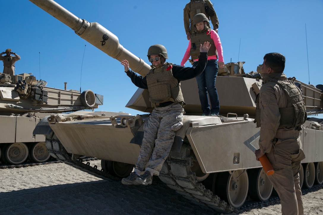 Amanda Boos, wife of Capt. Jonathon Boos, 1st Tank Battalion, sits on an M1A1 Abrams Main Battle Tank during the battalion’s Jane Wayne Day at Range 500 aboard Marine Corps Air Ground Combat Center, Twentynine Palms, Calif., March 2, 2017. The event is held to bolster unit cohesion while allowing the spouses to see what their Marines and sailors do on a daily basis. (U.S. Marine Corps photo by Cpl. Julio McGraw)
