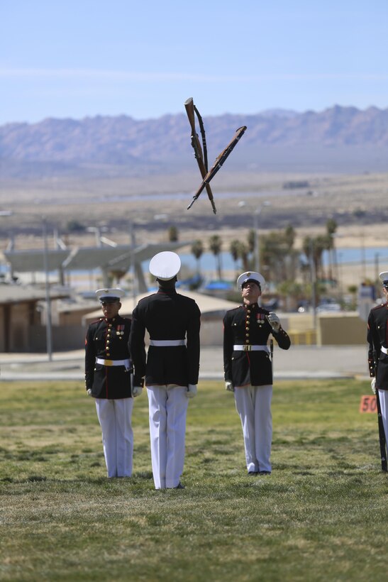 Marines with the U.S. Marine Corps Silent Drill Platoon perform a drill movement during the Battle Color Ceremony at Lance Cpl. Torrey L. Gray Field aboard Marine Corps Air Ground Combat Center, Twentynine Palms, Calif., March 8, 2017. The U.S. Marine Corps Battle Color Detachment travels worldwide annually to demonstrate the discipline and “Esprit de Corps” of Marines. (U.S. Marine Corps photo by Lance Cpl. Natalia Cuevas)