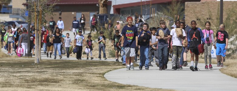 Fourth and fifth-grade students from Palm Vista Elementary school arrive at Victory Park to have lunch with Marines from 3rd Battalion, 4th Marines, 7th Marine Regiment following the annual Battle Color Ceremony at Lance Cpl. Torrey L. Gray Field aboard Marine Corps Air Ground Combat Center, Twentynine Palms, Calif., March 8, 2017. 3-4 adopted the elementary school in order to mentor the children.  (U.S. Marine Corps photo by Lance Cpl. Natalia Cuevas)