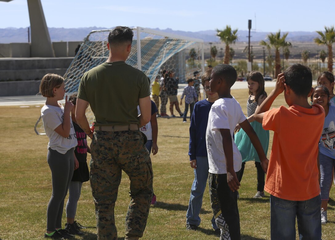 Marines with 3rd Battalion, 4th Marines, 7th Marine Regiment interact with Fourth and fifth-grade students from Palm Vista Elementary school at Victory Park at Victory Park following the annual Battle Color Ceremony at Lance Cpl. Torrey Field aboard Marine Corps Air Ground Combat Center, Twentynine Palms, Calif., March 8, 2017. 3/4 adopted the elementary school in order to mentor the children.  (U.S. Marine Corps photo by Lance Cpl. Natalia Cuevas)