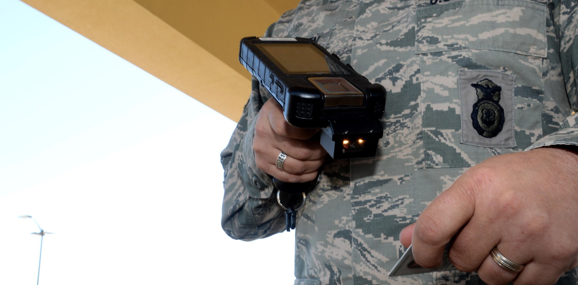 Tech. Sgt. Jason VanMeeteren, Visitor Center Pass and Identification Non-Commissioned Officer in Charge, scans a Common Access Card through one of the new Defense Biometrics Identification Systems, March 8, 2017, Maxwell Air Force Base, Ala. The DBIDS is a card scanning device that uses barcodes and biometrics to identify individuals. (U.S. Air Force photo/ Senior Airman Alexa Culbert)

