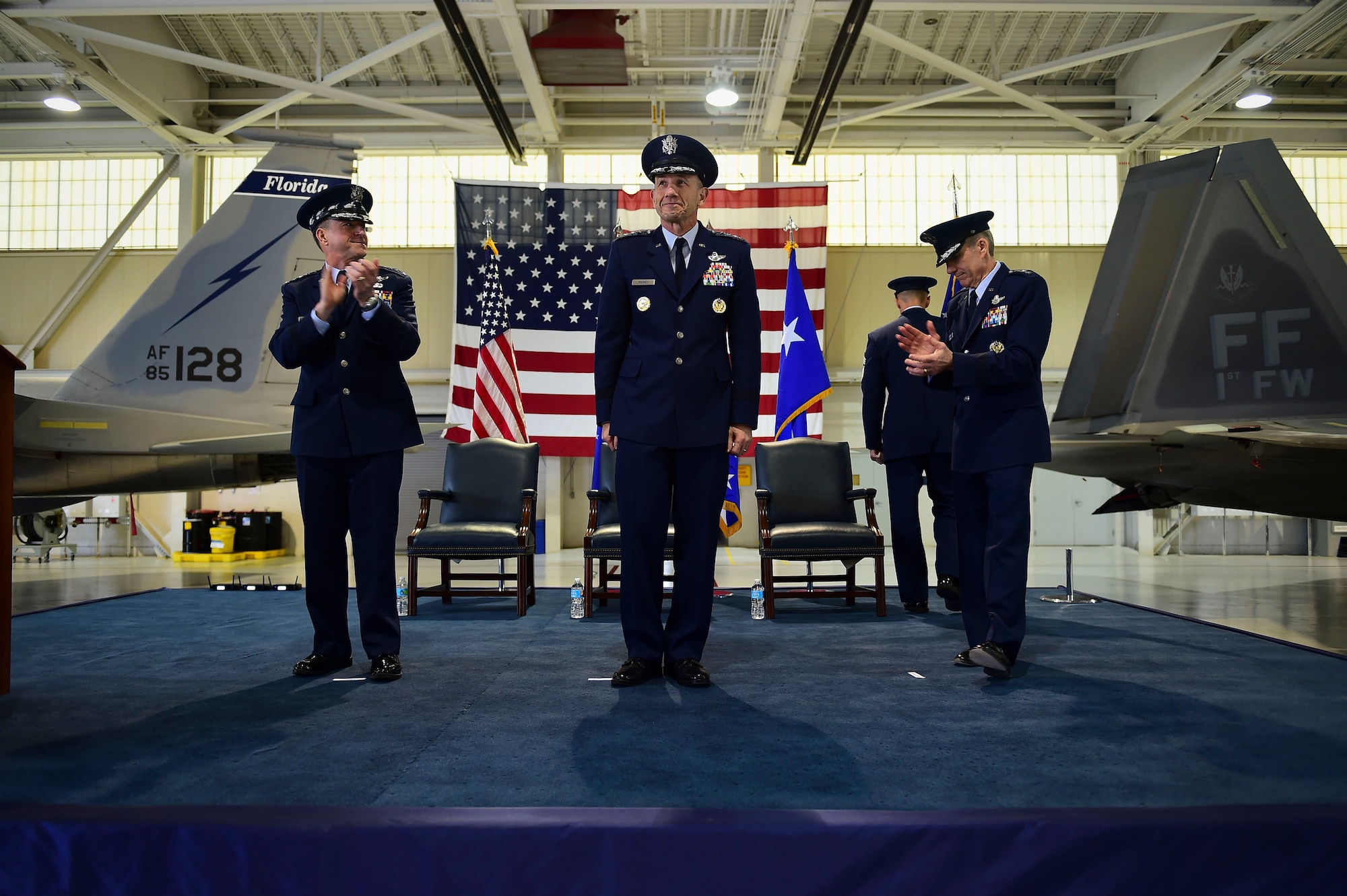 U.S. Air Force Chief of Staff Gen. David L. Goldfein, and General Hawk Carlisle, former commander, Air Combat Command, lead an applause for Gen. James M. Holmes, Commander, ACC, during ACC’s Change of Command ceremony at Joint Base Langley-Eustis, Va., March 10, 2017. Holmes assumed command from Carlisle, who retired after 39 years of service to the Air Force. (U.S. Air Force photo by Senior Airman Kimberly Nagle) 