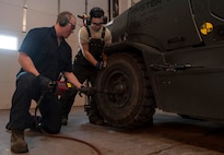 (From left) Senior Airman Nicholas Oukrop, 5th Logistics Readiness Squadron vehicle maintenance technician, and Airman Steven Velasquez, 5th LRS vehicle maintenance technician, tighten lug nuts onto a forklift at Minot Air Force Base, N.D., Feb. 28, 2017. The tire shop ensures all government vehicle’s readiness by performing daily tire maintenance. (U.S. Air Force photo/Airman 1st Class Jonathan McElderry)