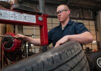 Senior Airman Nicholas Oukrop, 5th Logistics Readiness Squadron vehicle maintenance technician, replaces an old tire at Minot Air Force Base, N.D., Feb.28, 2017. The maintainers use a tire clamp machine to remove each tire from its rim while performing maintenance. (U.S. Air Force photo/Airman 1st Class Jonathan McElderry)