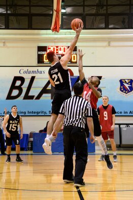 2nd Lt. Dylan Flynn, Specialized Undergraduate Pilot Training Class 17-07, and Airman 1st Class Henry Scott, 14th Operations Support Squadron Air Traffic Controller, kick off the 2017 Intramural Basketball Championship between the 14th Student Squadron and RAPCON with a jump ball March 2, 2017, at Columbus Air Force Base, Mississippi. The 14th STUS started strong and finished by defeating RAPCON 51 to 39. (U.S. Air Force photo by Airman 1st Class Beaux Hebert) 
