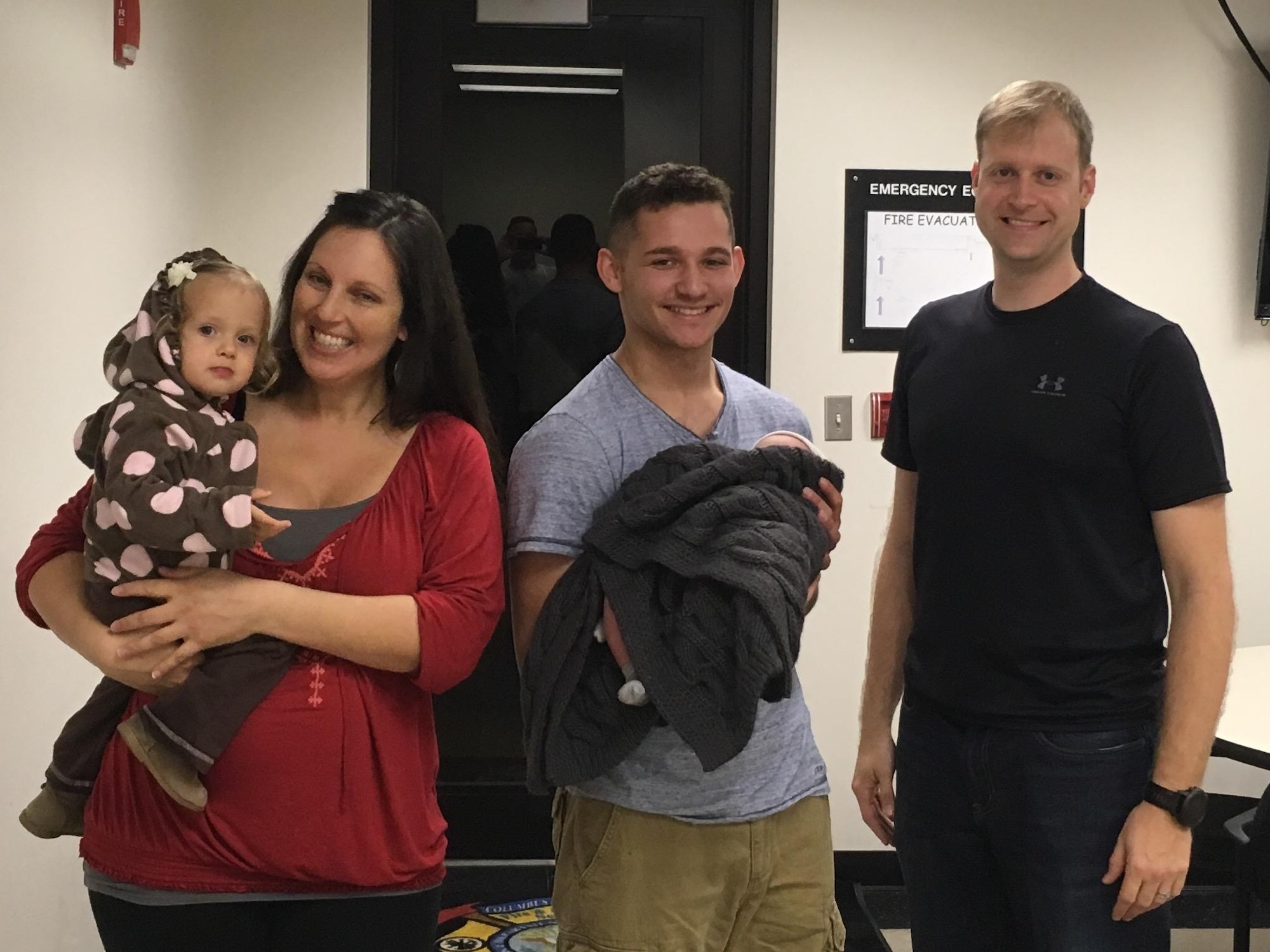 Abby Meskimen, mother of the newborn, Airman 1st Class Deangelo Wallman-Sims, 14th Civil Engineer Squadron Firefighter and Maj. Scott Meskimen, 14st Flying Training Squadron Instructor Pilot, hold the newborn baby boy, Khyrim Nikao and their daughter, Karamia, Feb. 10, 2017, at the Fire Station on Columbus Air Force Base, Mississippi. A team of seven Emergency Medical Responders responded to a call about a newborn baby that was not breathing. The EMRs provided care to both patients, resulting in the baby breathing on its own. (Courtesy photo) 
