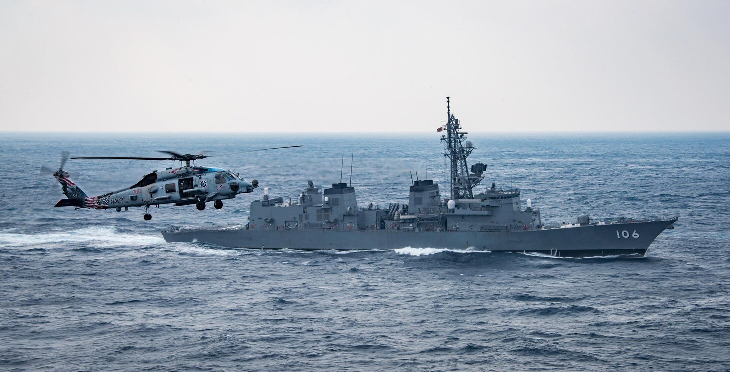 An MH-60R Sea Hawk from the “Blue Hawks” of Helicopter Maritime Strike Squadron (HSM) 78 flies near the Japan Maritime Self-Defense Force Murasame-class destroyer JS Samidare (DD 106) and the aircraft carrier USS Carl Vinson (CVN 70), not pictured, Mar. 8, 2017. The Carl Vinson Carrier Strike Group is on a regularly scheduled Western Pacific deployment as part of the U.S. Pacific Fleet-led initiative to extend the command and control functions of U.S. 3rd Fleet. U.S. Navy aircraft carrier strike groups have patrolled the Indo-Asia-Pacific regularly and routinely for more than 70 years. 